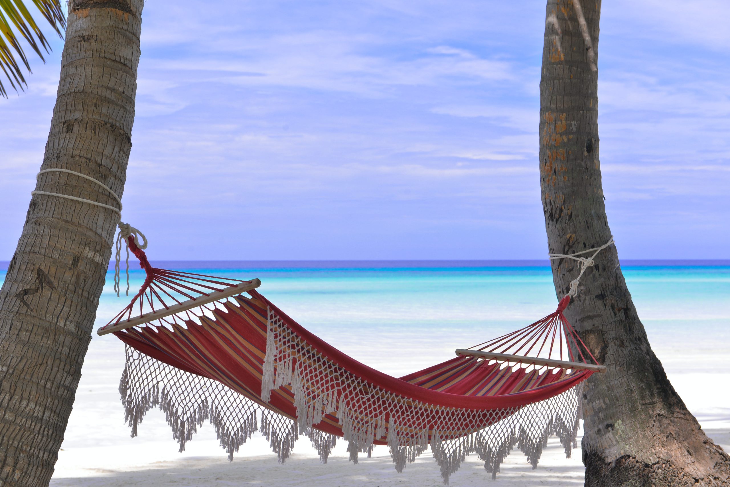 Inviting beachside relaxation in Tulum with a hammock overlooking turquoise waters